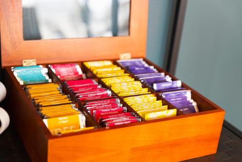 a wooden box filled with different colored boxes at Ténéo Apparthotel Talence - Centre in Talence