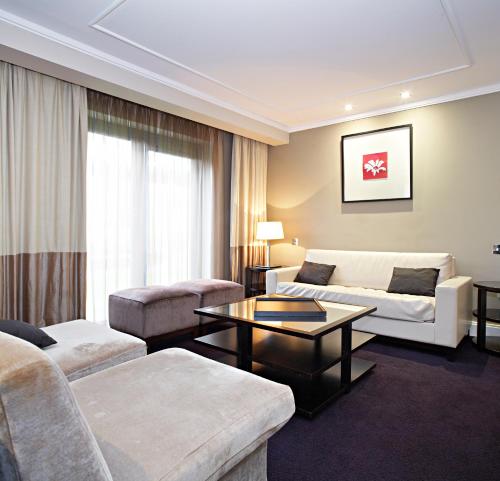 a living room with a couch and a table at Shamrock Lodge Hotel in Athlone