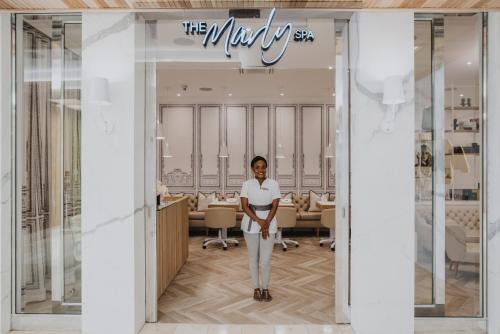 a man is standing in front of a kitchen at The Marly Boutique Hotel in Cape Town