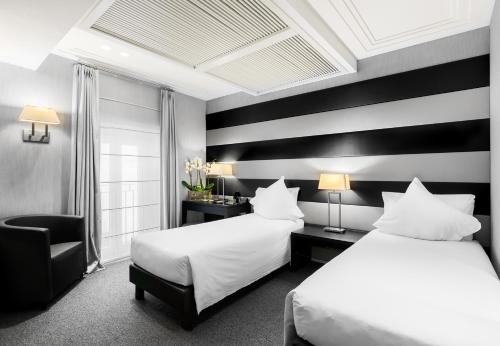 Postel nebo postele na pokoji v ubytování Hotel Mancino 12