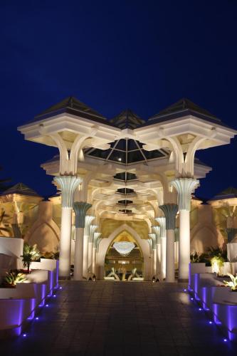a building with white columns and purple lights at night at Hasdrubal Prestige Thalassa & Spa Djerba in Triffa