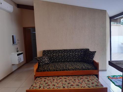 a couch sitting against a wall in a room at Pousada Ilha Sul in Cananéia