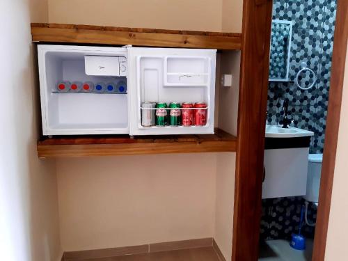 a small cabinet with drinks in it in a room at Pousada Ilha Sul in Cananéia