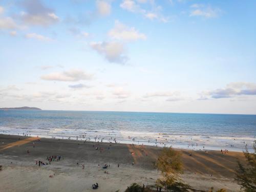 a group of people on a beach near the ocean at TIMURBAY KUANTAN -BEACHFRONT PARADISE GETAWAY in Kuantan