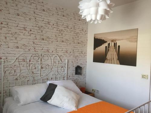 a bedroom with a bed and a brick wall at Last Minute Herzliya in Herzelia 