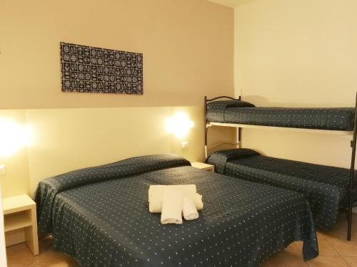 2 łóżka w pokoju z 2 łóżkami piętrowymi w obiekcie Hotel Atmosfere Beach w Cesenatico
