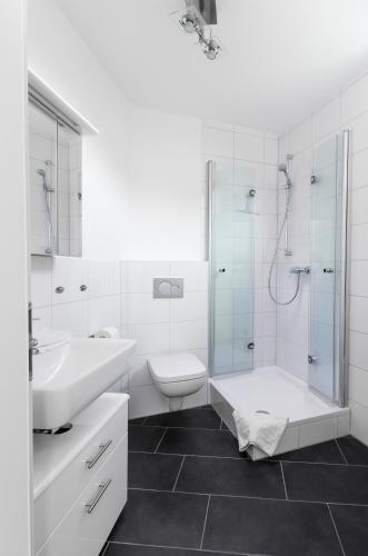 a bathroom with a sink toilet and a shower at Quiet Nature Near Cologne 2 in Bergisch Gladbach