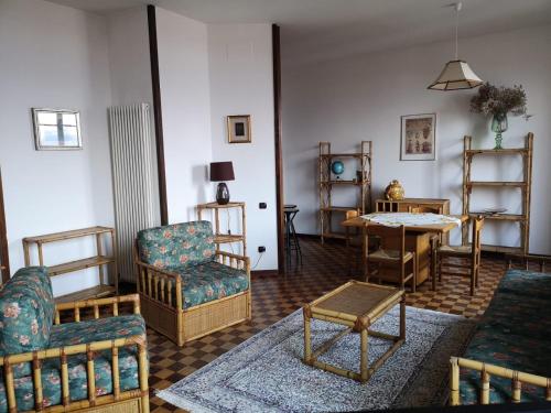 een woonkamer met meubilair en een tafel bij Appartamento LE DUE ROCCHE in Arona