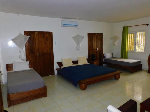 En eller flere senger på et rom på Villa Ty Milyn Mazela SA