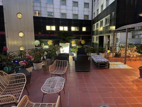 a patio with chairs and tables and buildings at B&B Mini Hotel Incity-close train station and port- in Salerno