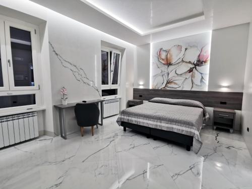 a bedroom with a bed and a desk and a painting at Hotel Valentino Palace in Rome