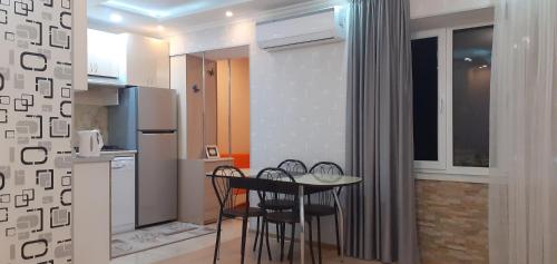 a kitchen with a table and chairs in a room at Apartment ANI in Vagharshapat