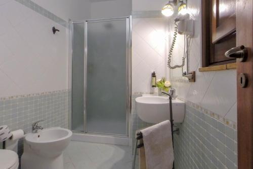a bathroom with a shower and a toilet and a sink at Donnaciccina Accomodation in Tropea