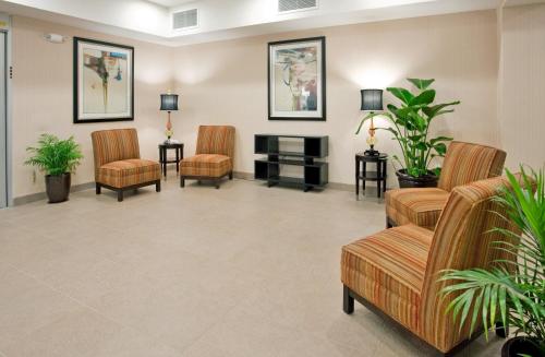 a waiting room with chairs and a fireplace at Holiday Inn Express Topeka North, an IHG Hotel in Topeka