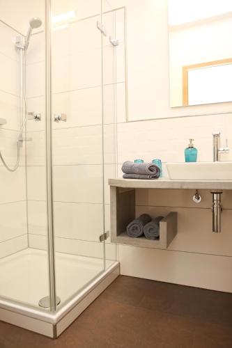 a bathroom with a shower and a sink at Gasthof Hotel Adler Inneringen in Inneringen-Hettingen