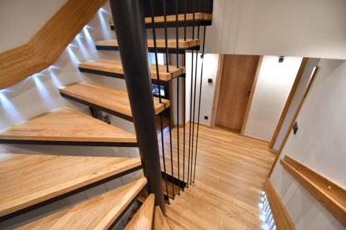 a spiral staircase in a house with wooden floors at Tweed house in Budapest