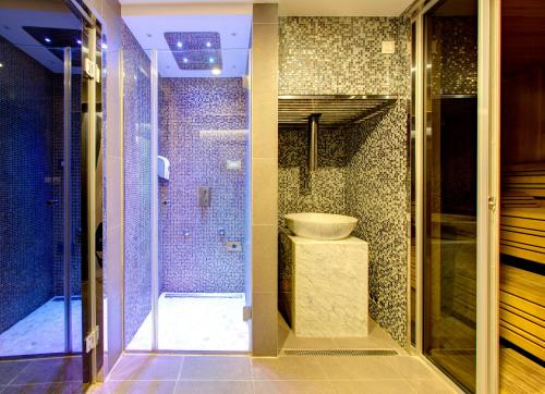a bathroom with a shower stall and a toilet at Hotel Eden in Mostar