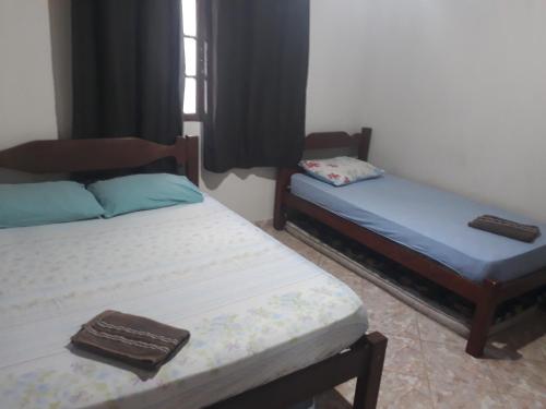 Casa de praia P Grande tesisinde bir odada yatak veya yataklar