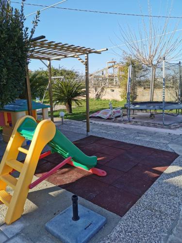 a playground with a slide in a park at Villa Rosa in Modica