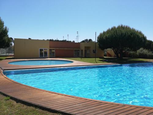 a large swimming pool in front of a building at Villa Confort - FURADOURO in Ovar