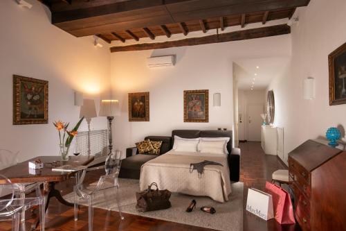 a bedroom with a bed and a living room at Riccardo Condotti Suite in Rome