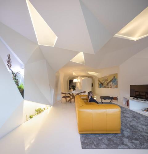 a living room with a yellow couch and a table at LeBlanche in Porto