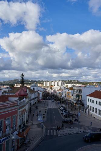a view of a city with cars parked on a street at Downtown Loulé in Loulé