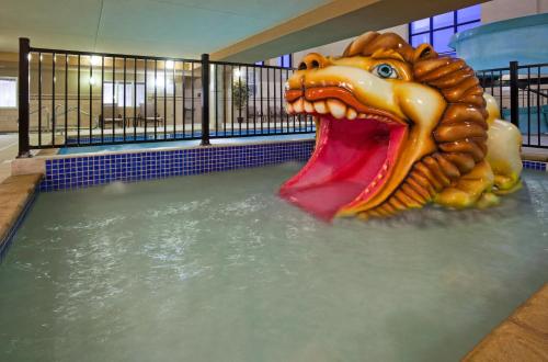 a water slide with a dragon head in a pool at Holiday Inn Express & Suites Mitchell by IHG in Mitchell