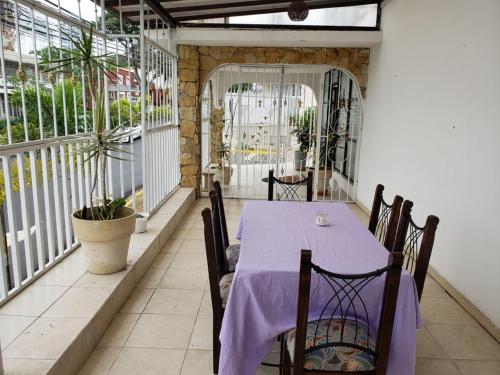 a table with a purple table cloth on a balcony at HOTEL TERRAZAS BOUTIQUE in Los Yoses