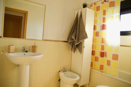 a bathroom with a sink and a toilet and a mirror at The Blue Torrent, perfect for relaxing getaway in La Oliva
