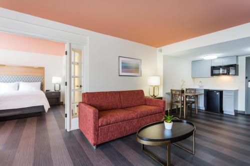 a hotel room with a bed and a couch and a table at Holiday Inn Timonium by IHG in Timonium