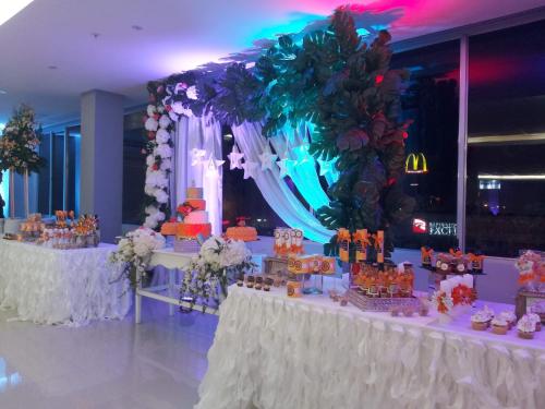 a wedding reception with a table with a cake on it at Hotel City Plaza & Suites in David