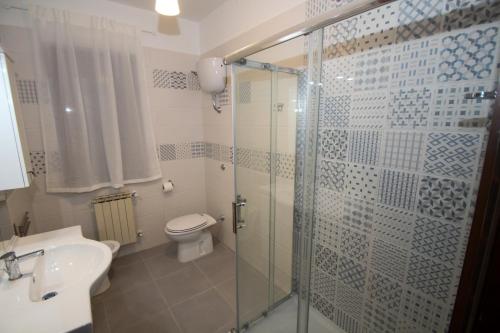 a bathroom with a shower and a toilet and a sink at AceroRosso B&B in Salerno