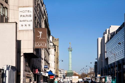 a busy city street with a view of the eiffel tower at Paris Bastille in Paris