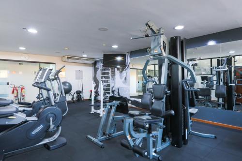 a gym with several treadmills and weights at Radisson Hotel Belém in Belém