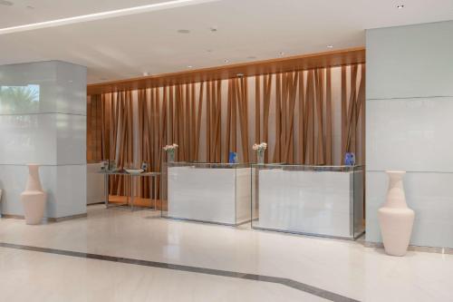 a lobby with two tables and two vases at Radisson Blu Hotel & Residence, Riyadh Diplomatic Quarter in Riyadh
