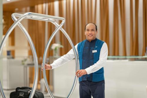 a man standing next to a metal object at Radisson Blu Hotel & Residence, Riyadh Diplomatic Quarter in Riyadh