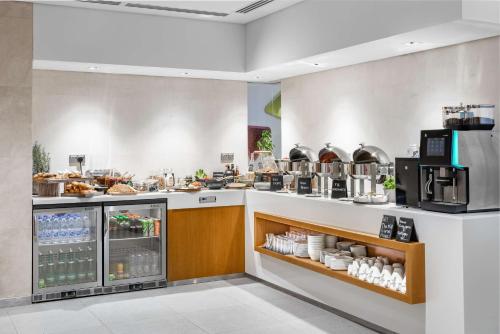 a restaurant kitchen with a counter with food at Radisson Blu Hotel & Residence, Riyadh Diplomatic Quarter in Riyadh