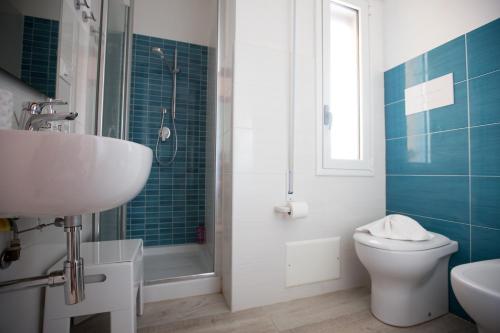 a bathroom with a sink and a toilet and a shower at Appartamenti Cala Azzurra in Scopello