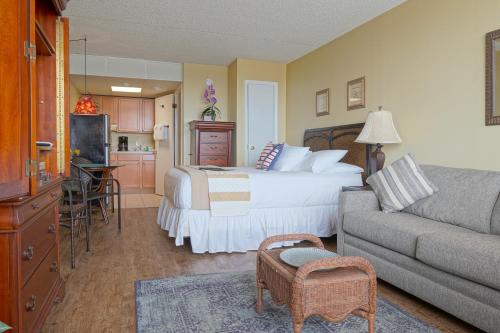 a hotel room with a bed and a couch at The Crossings Ocean City in Ocean City
