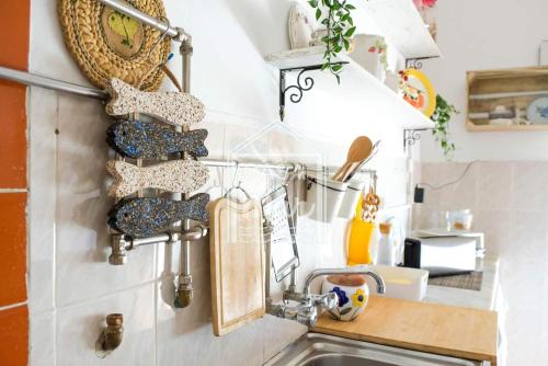 a kitchen with a sink and a counter with utensils at Casa do Mar - Nazaré in Nazaré