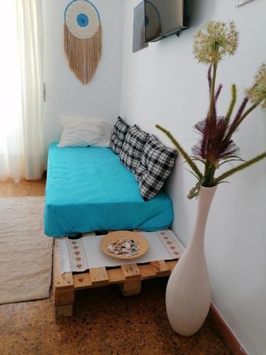 a living room with a couch and a table with a vase at Casa do Mar - Nazaré in Nazaré
