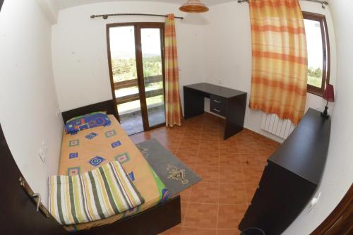 a bedroom with a bed and a desk and a window at Villa SALAM in Ifrane