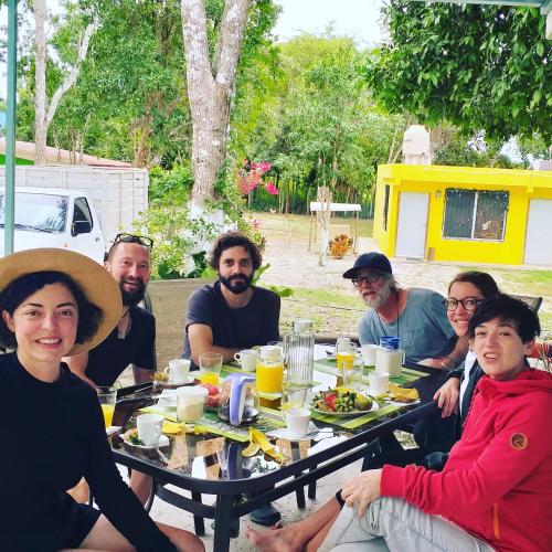 a group of people sitting around a table eating food at Otoch Béek Calakmul in Chicanna