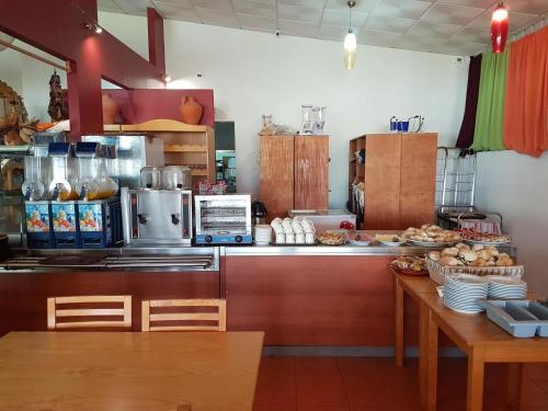 een keuken met een aanrecht en een tafel met eten bij Casa da Felicidade in Pataias