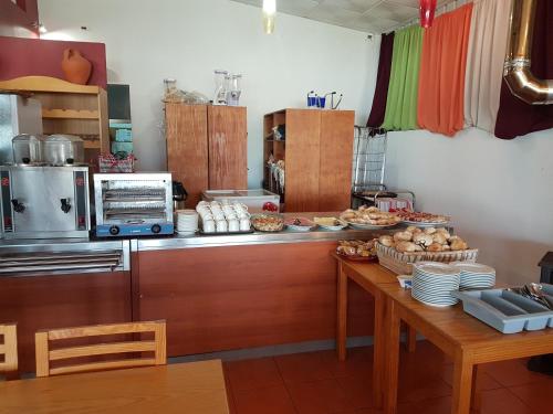 een keuken met een tafel met eten erop bij Casa da Felicidade in Pataias