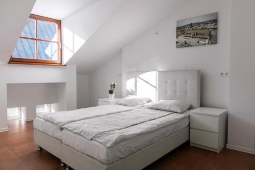 a white bedroom with a large bed and a window at MK Apartment 100m2 Friends&Family in Krakow