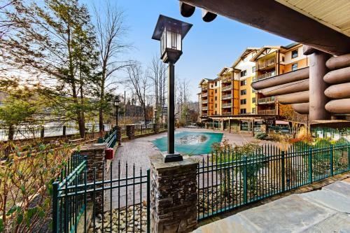 a fence with a street light next to a swimming pool at Baskin's Creek Condos III in Gatlinburg