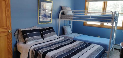 a bedroom with two bunk beds and a bed at Red Ranch Inn in Catskill