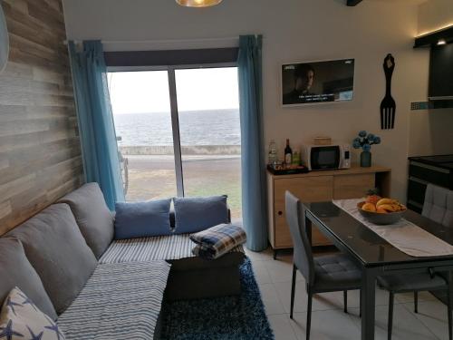 a living room with a couch and a table at Cantinho do Ilhéu in Ponta Delgada